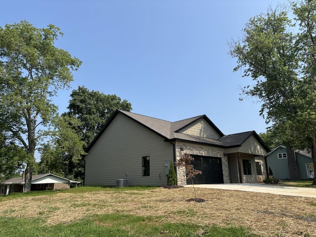 2901 Bobo Ave NW, Cleveland, TN 37312 - view of home's exterior featuring driveway, an attached garage, and stone siding