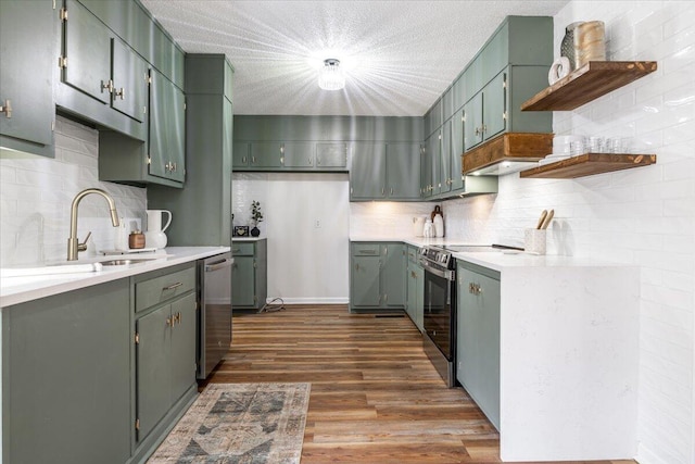 kitchen featuring decorative backsplash, appliances with stainless steel finishes, dark hardwood / wood-style flooring, a textured ceiling, and sink