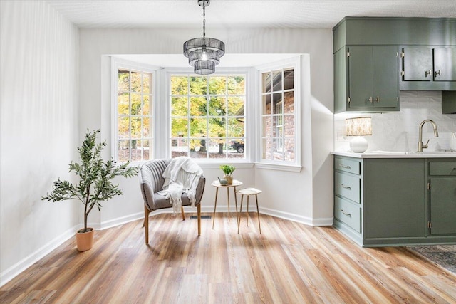 living area with light wood-type flooring and sink