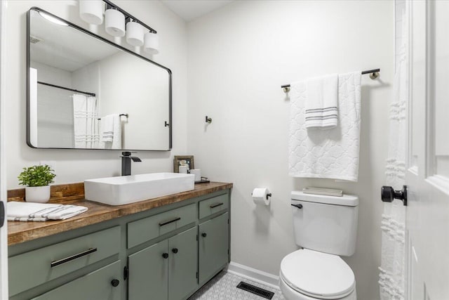 bathroom with tile patterned floors, vanity, curtained shower, and toilet