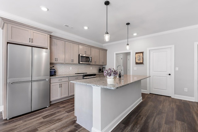 kitchen with hanging light fixtures, dark wood-type flooring, stainless steel appliances, light stone counters, and a center island with sink