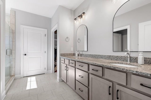 bathroom featuring vanity, tile patterned floors, and an enclosed shower