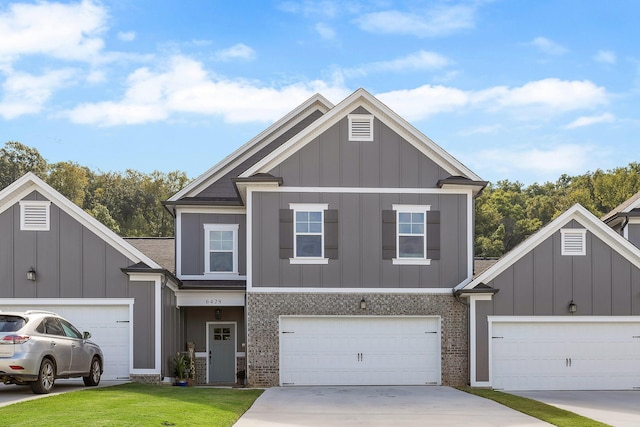 view of front of home with a front lawn and a garage