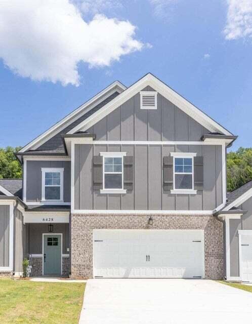 view of front of property with a garage and a front lawn