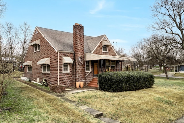 view of side of property featuring a lawn and a porch