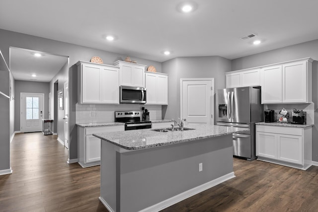 kitchen with sink, appliances with stainless steel finishes, an island with sink, light stone countertops, and white cabinets