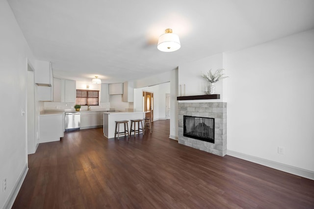 unfurnished living room featuring dark hardwood / wood-style flooring and sink