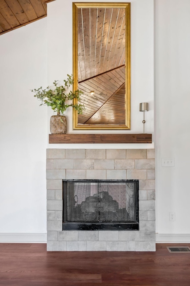 interior details with hardwood / wood-style flooring and a tile fireplace