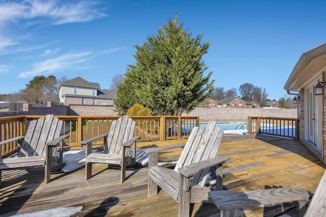 wooden terrace featuring a swimming pool