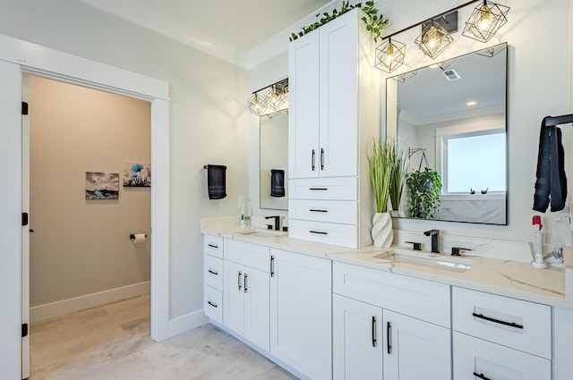 bathroom with vanity and ornamental molding