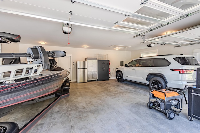 garage featuring a garage door opener and stainless steel refrigerator