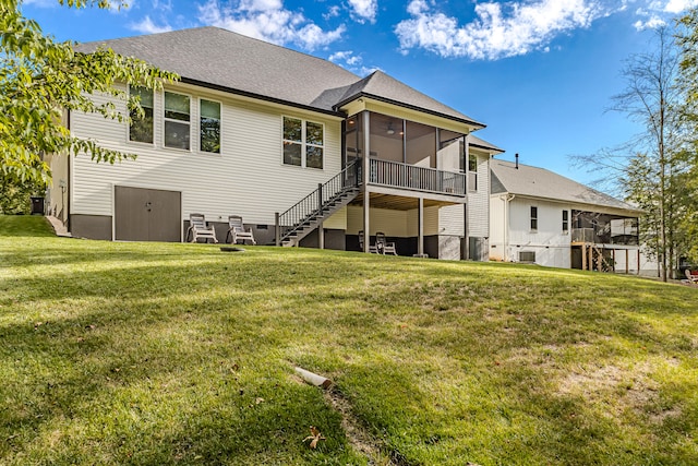 back of house featuring a lawn, a sunroom, and central AC unit