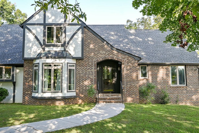 tudor home with a front yard