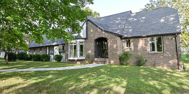 english style home with a front lawn