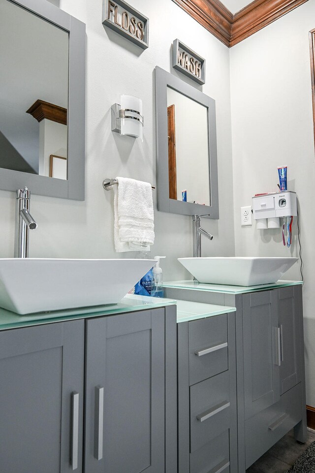 bathroom featuring tile patterned flooring, vanity, and ornamental molding