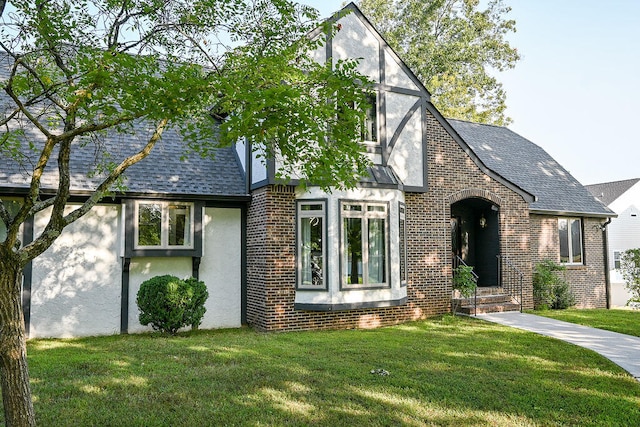 tudor house featuring a front yard