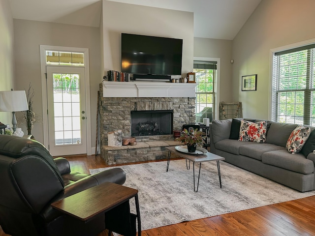 5755 Frontage Rd NW, Cleveland, TN 37312 - living room with lofted ceiling, wood finished floors, and a stone fireplace