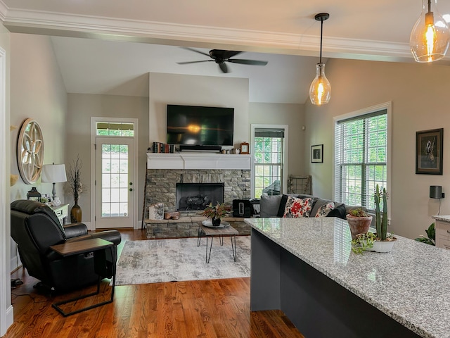 5755 Frontage Rd NW, Cleveland, TN 37312 - living area featuring crown molding, ceiling fan, wood finished floors, a stone fireplace, and vaulted ceiling