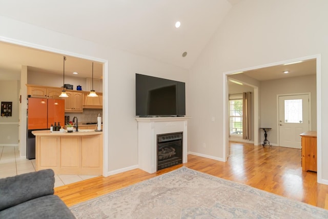 328 Mill Hamlet Rd NW, Charleston, TN 37310 - living area with light wood-type flooring, a fireplace, baseboards, high vaulted ceiling, and recessed lighting