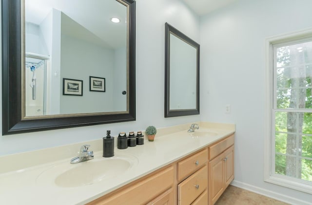 328 Mill Hamlet Rd NW, Charleston, TN 37310 - bathroom with double vanity, healthy amount of natural light, and baseboards