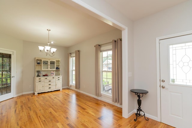 328 Mill Hamlet Rd NW, Charleston, TN 37310 - foyer entrance with a chandelier, light wood-style flooring, and baseboards
