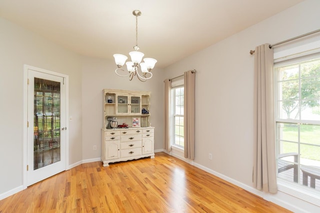 328 Mill Hamlet Rd NW, Charleston, TN 37310 - spare room featuring a chandelier, plenty of natural light, light wood-style flooring, and baseboards