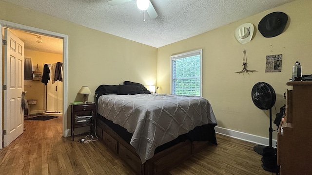 122 Meredith Dr, Turtletown, TN 37391 - bedroom featuring a textured ceiling, dark wood-style flooring, baseboards, and a ceiling fan