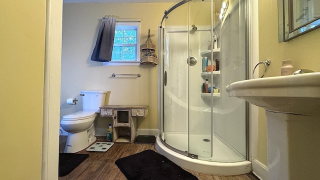 122 Meredith Dr, Turtletown, TN 37391 - full bathroom featuring a shower stall, toilet, and wood finished floors