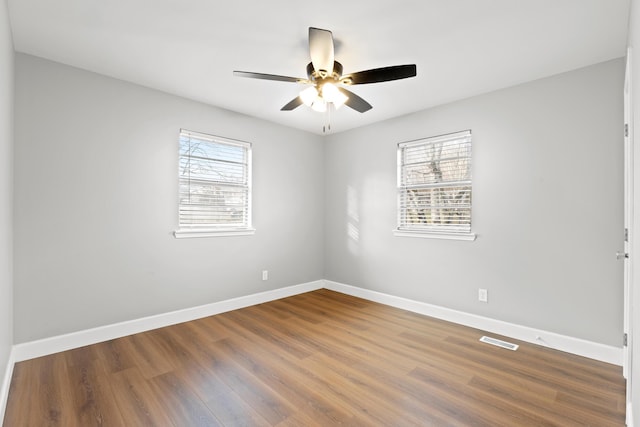 empty room with wood-type flooring and ceiling fan