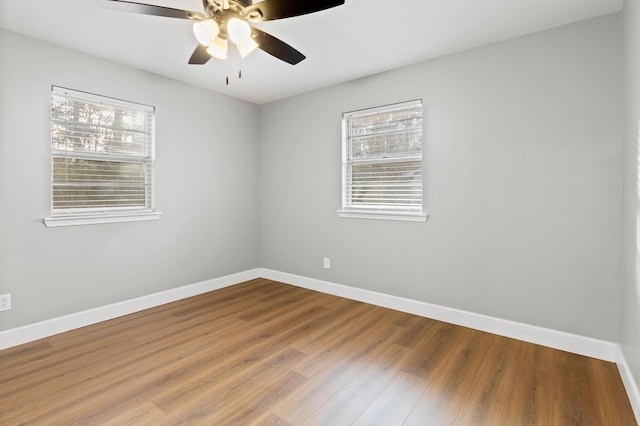 empty room with ceiling fan and hardwood / wood-style floors