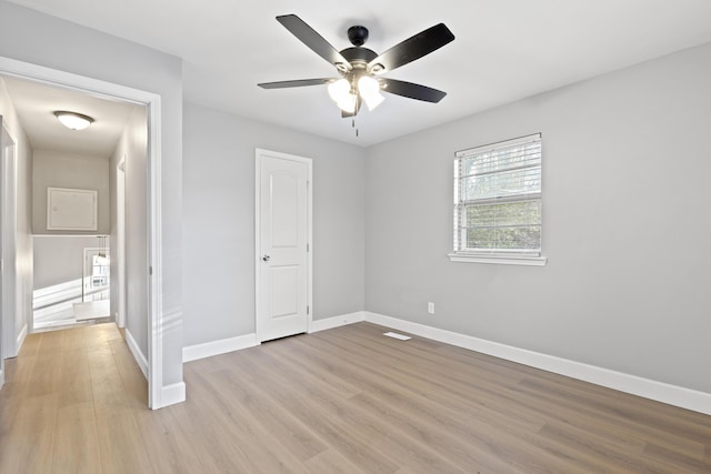 unfurnished bedroom with ceiling fan and light hardwood / wood-style flooring