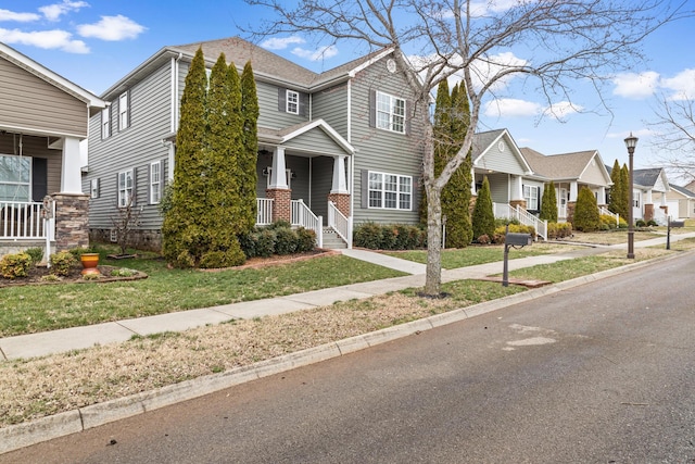 view of front of home featuring brick siding, a front lawn, and a residential view