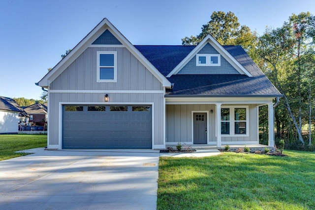 view of front of house featuring a porch, a garage, and a front yard