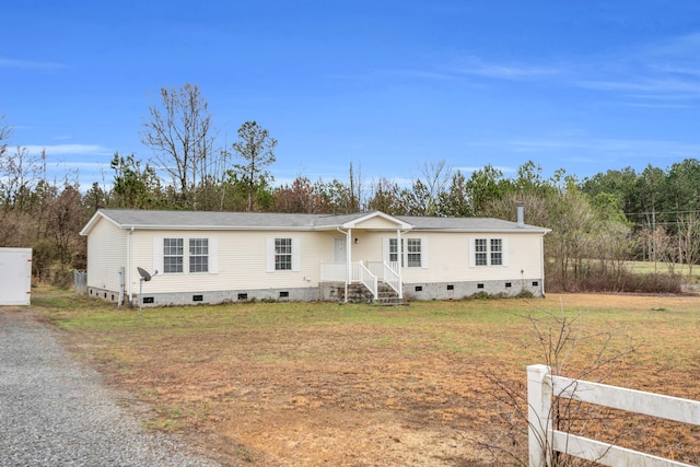 manufactured / mobile home featuring crawl space and a front lawn