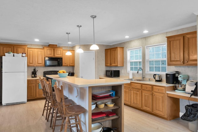 kitchen featuring a sink, a center island, black microwave, freestanding refrigerator, and open shelves