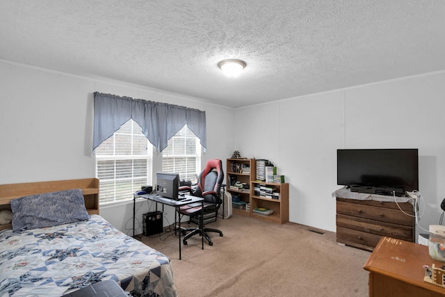 bedroom featuring carpet flooring and a textured ceiling