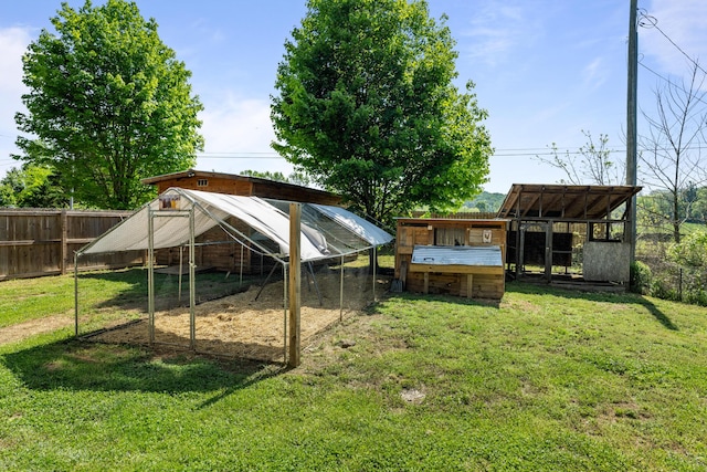 view of yard with exterior structure, an outbuilding, and a fenced backyard