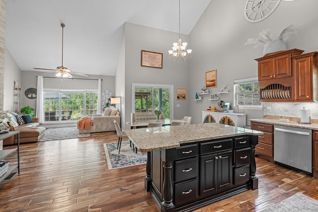 kitchen featuring high vaulted ceiling, open floor plan, and dishwasher
