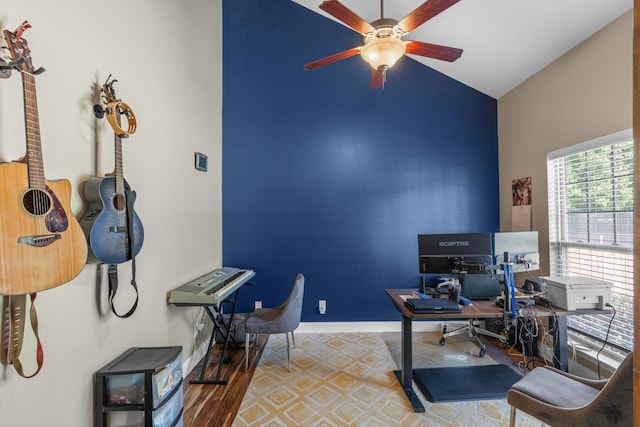 office area featuring a ceiling fan, baseboards, and vaulted ceiling