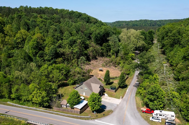 drone / aerial view featuring a forest view