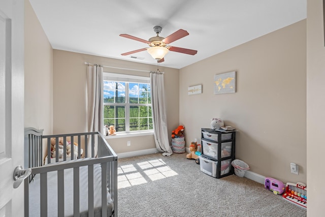 bedroom featuring carpet floors, a ceiling fan, baseboards, and a nursery area