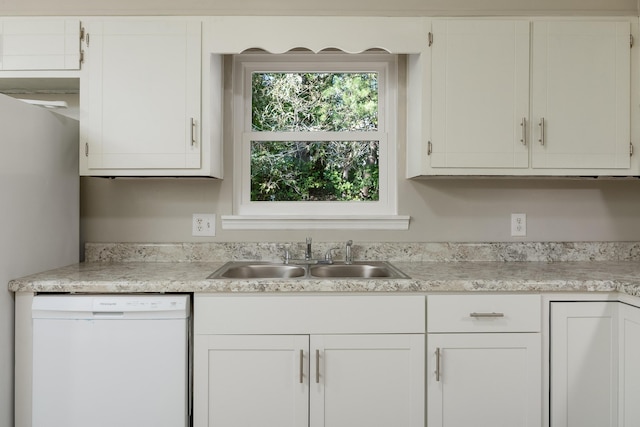 kitchen featuring stainless steel fridge, white dishwasher, white cabinetry, and sink