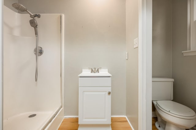 bathroom featuring vanity, wood-type flooring, and walk in shower