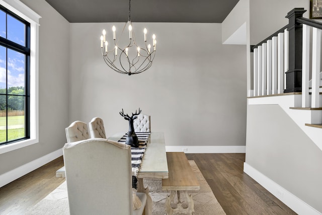 dining area with a notable chandelier, plenty of natural light, and dark hardwood / wood-style floors