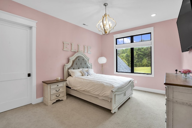 carpeted bedroom featuring a chandelier