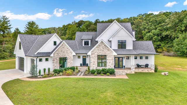 modern inspired farmhouse featuring a front yard and a garage