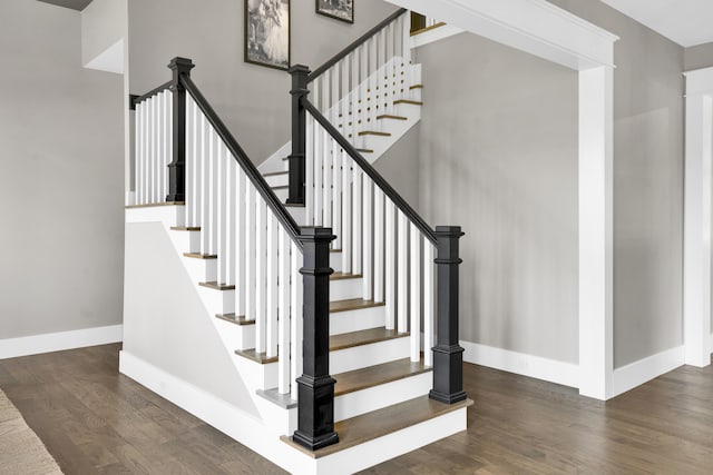 stairway with hardwood / wood-style floors