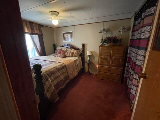 carpeted bedroom featuring ceiling fan and a textured ceiling