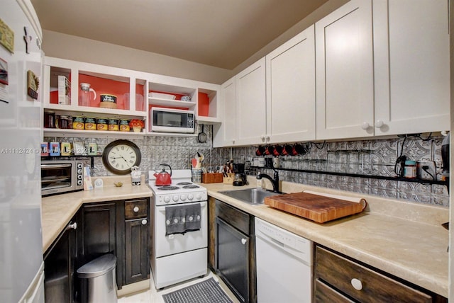 kitchen featuring white cabinetry, white appliances, sink, tasteful backsplash, and dark brown cabinetry