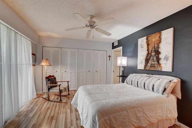 bedroom with a textured ceiling, a closet, ceiling fan, and light hardwood / wood-style flooring